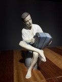 Antique statuette of a boy with an accordeon