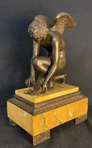 Antique sculpture "Cupid playing with a butterfly"