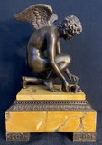 Antique sculpture "Cupid playing with a butterfly"