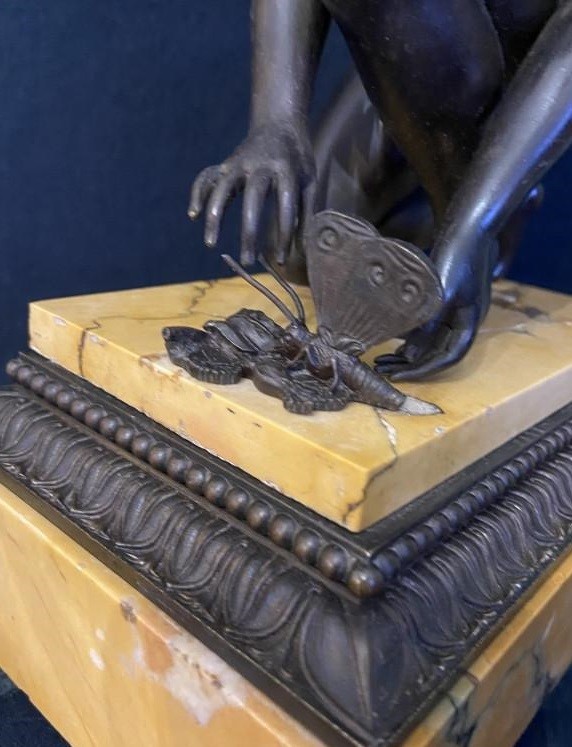 Antique sculpture "Cupid playing with a butterfly"