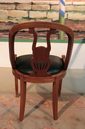 An ancient set of chairs in the Empire style. Made of mahogany, leather and bronze. Europe, the 1930s.