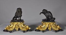 A pair of gilt bronze andirons and bronze with brown patina dog decor and chat