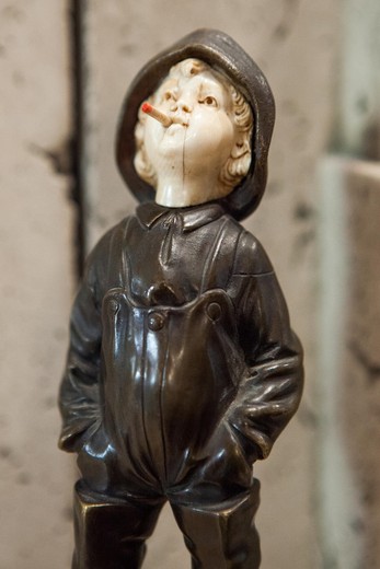 bronze statuette bouy with a cigarette