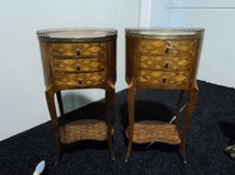 A pair of nightstands with marble top