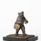 Antique bronze bear with a bag