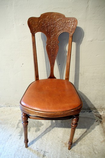Antique furniture a wooden chair with a leather seat Europe the beginning of the XXth Century