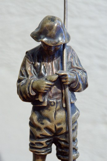 Antique objects for the interior decoration.  An antique statue " a boy with a fishing-rod". made out of bronze on the marble base.