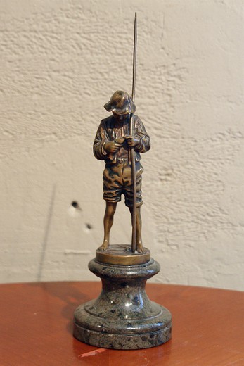 Old objects for the interior and gifts. A sculpture " a boy with fishing-rod". Made out of bronze on the marble base.