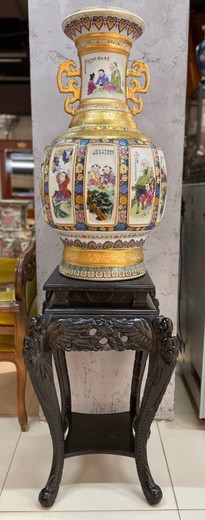 Large antique oriental vase on a pedestal.