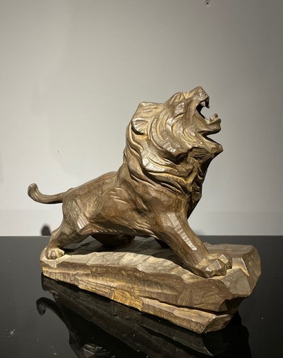 Antique sculpture of a lion on a rock
