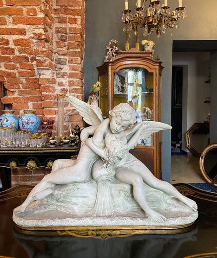 Antique sculpture of a young girl with an angel