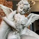 Antique sculpture of a young girl with an angel
