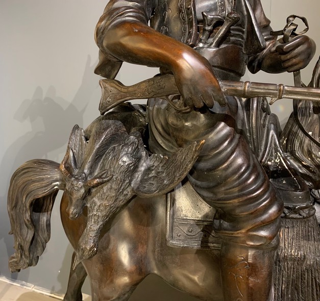 A large sculpture on a pedestal "Hunter with prey"