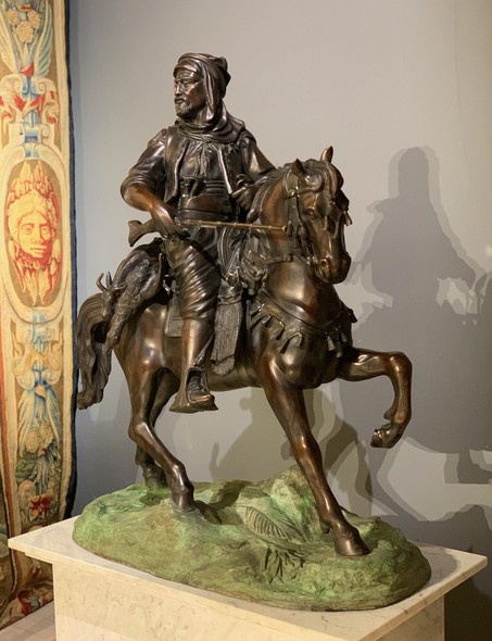 A large sculpture on a pedestal "Hunter with prey"