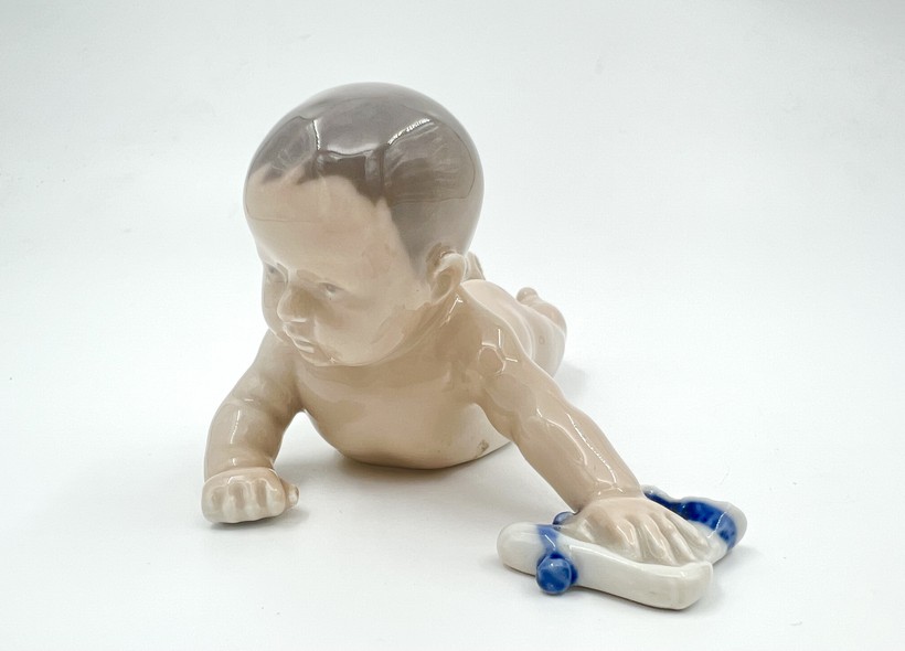 antique figurine "Baby with a sock"