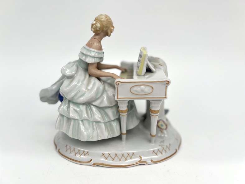 Antique sculpture "Girl at the piano"