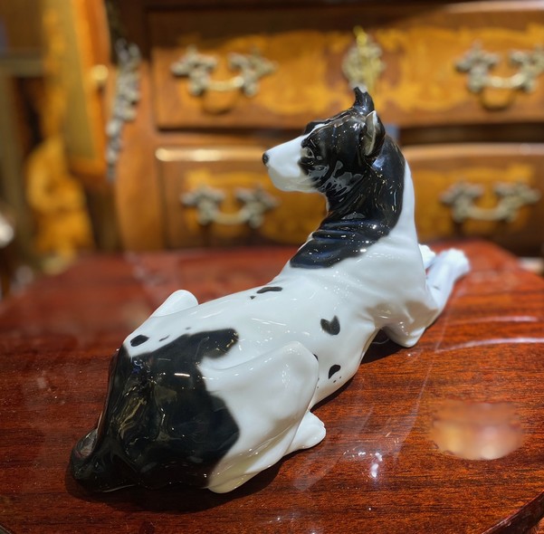 Antique figurine of a lying dog