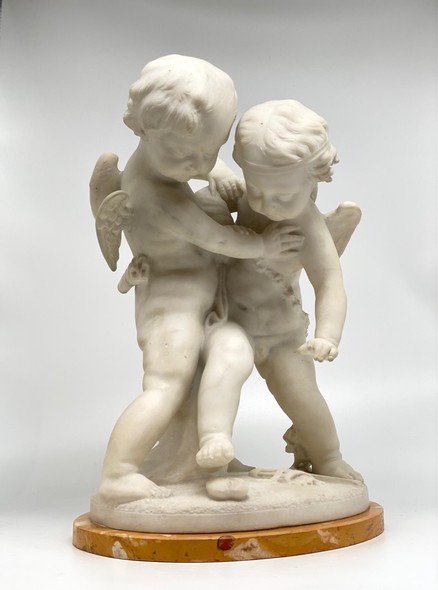 Antique sculpture "Cupids beating for the heart"