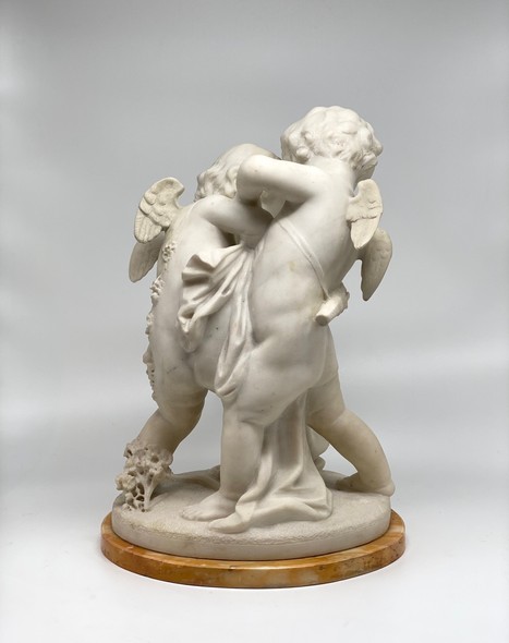 Antique sculpture "Cupids beating for the heart"