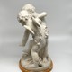 Antique sculpture "Cupids beating for the heart"