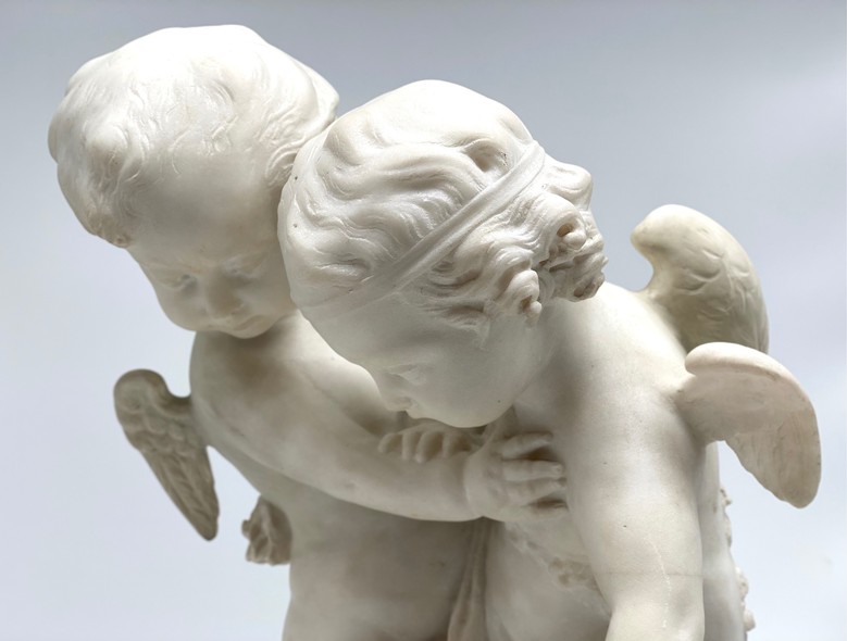 Antique sculpture "Cupids beating for the heart"