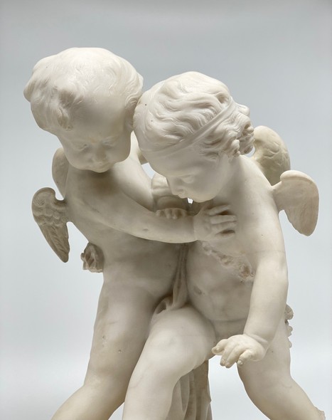 Antique sculpture "Cupids beating for the heart"