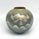 Vase with an image of flying cranes against a background of mountains