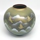 Vase with an image of flying cranes against a background of mountains