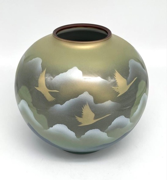 Vase with an image of flying cranes against a background of mountains