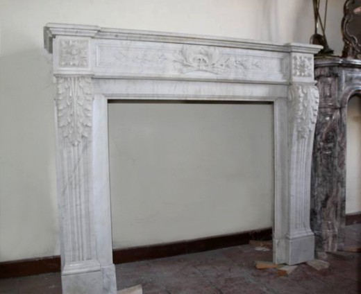 old fire mantel made of white carrara marble with classical carving in Louis XVI style