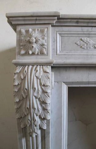 old fireplace mantel made of white carrara marble with classical carving in Louis XVI style