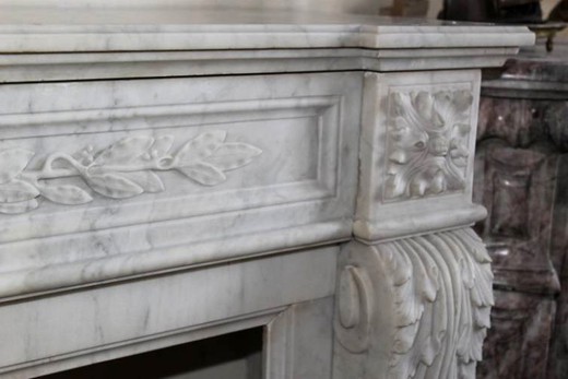 antique fireplace made out of white Carrar marble with classical carving Louis XVI style