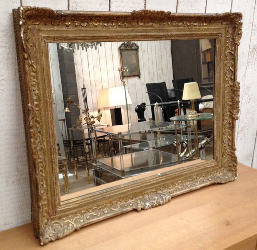 French antique wall mirror in carved wood frame. France, Montparnasse, circa 1900.