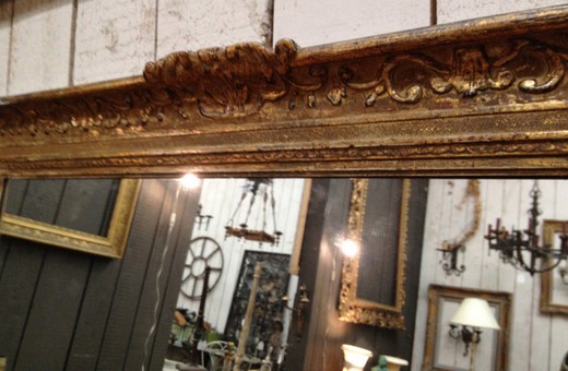 French old wall mirror in carved wood frame. France, Montparnasse, circa 1900.