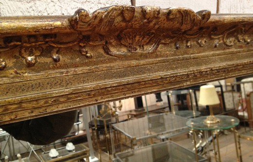 French old wall mirror in carved wood frame. France, Montparnasse, circa 1900.