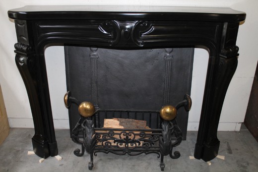 Exclusive old fireplace in Louis XV style. Made of black marble of Carrara. France, 19th century.