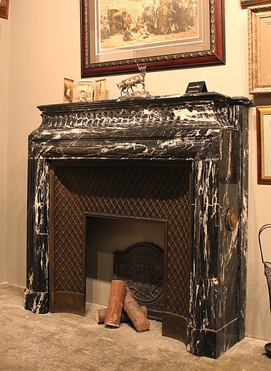 An old fireplace made out of black marble, antiques