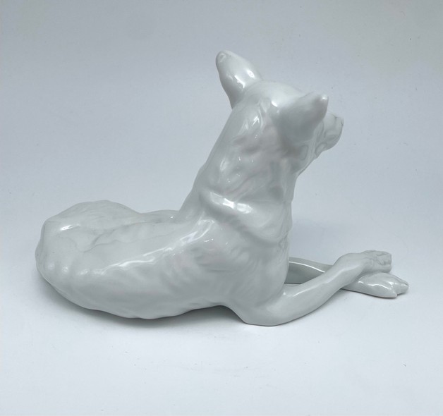 Antique figurine of a lying dog