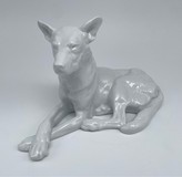 Antique figurine of a lying dog